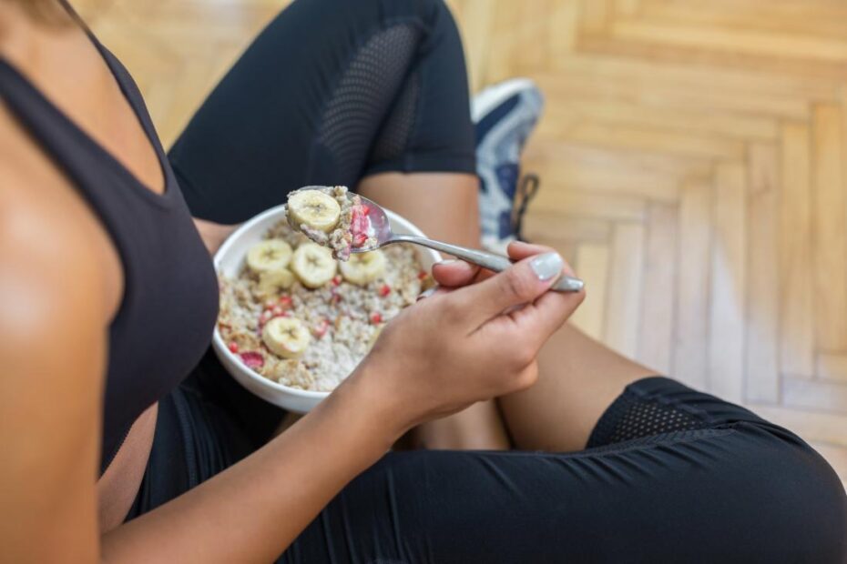 woman eating breakfast in workout clothes